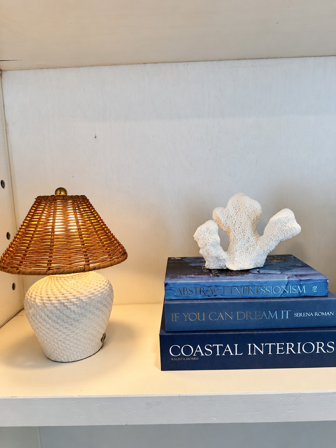 Woven lampshade, coral sculpture and coastal design books